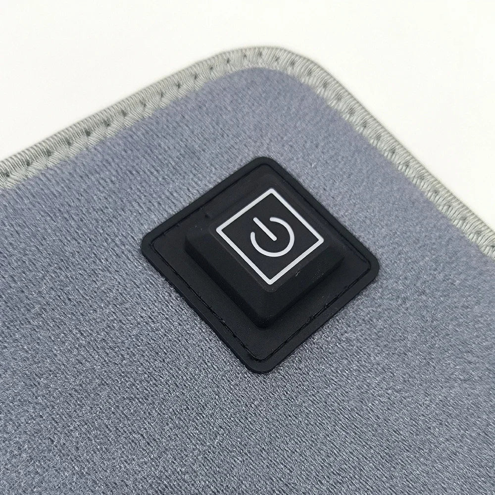 Close-up of a gray light therapy device with a black power button